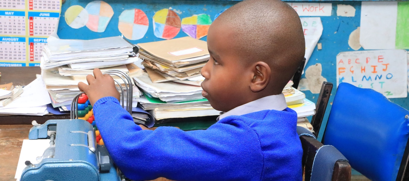 6-year-old Wesley Muturi in his class at Kilimani Primary School in Nairobi, using an abacus to count. / UNICEFKenya/2019/Ngochi 