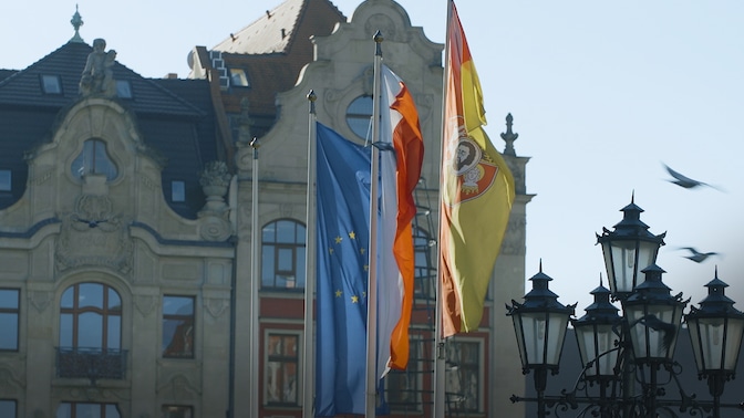 Flags hanging in front of buildings