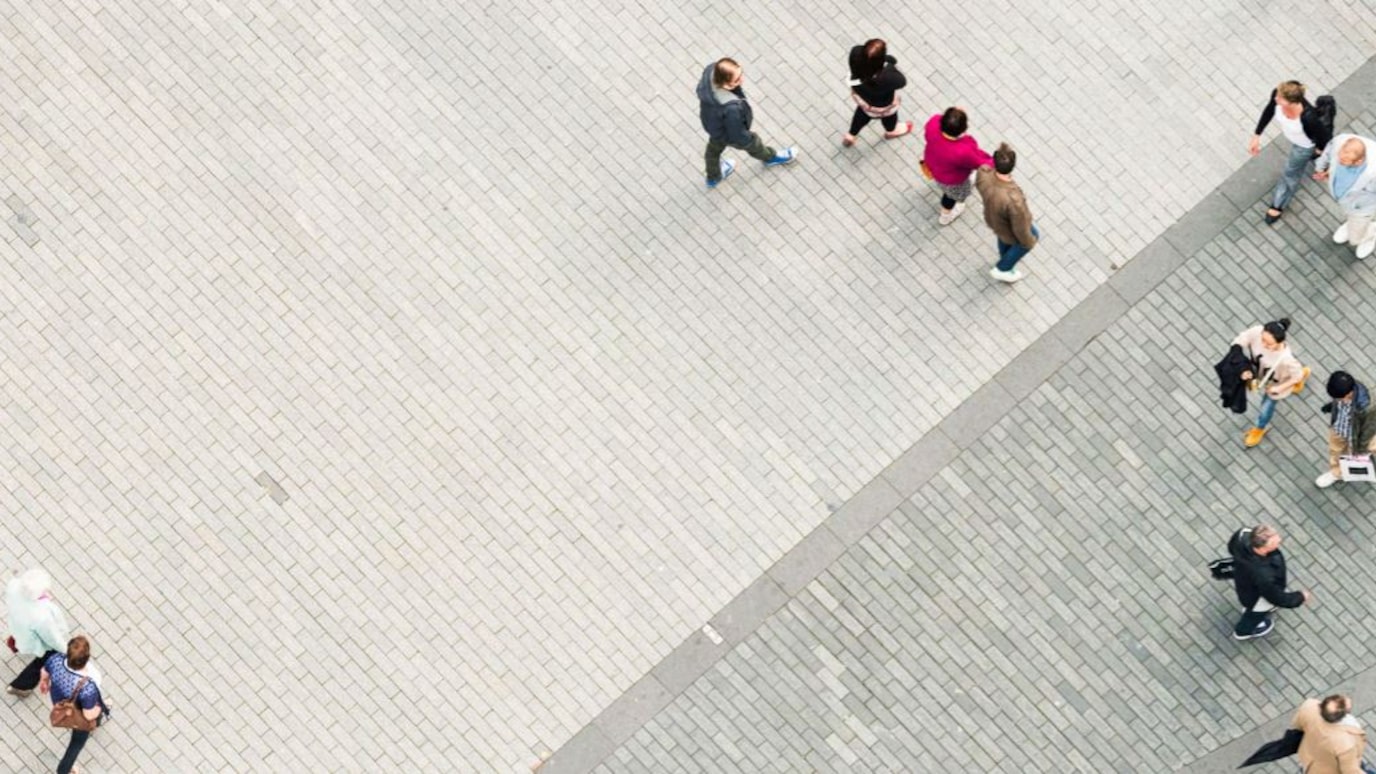 Overhead shot of people walking on brick walkway