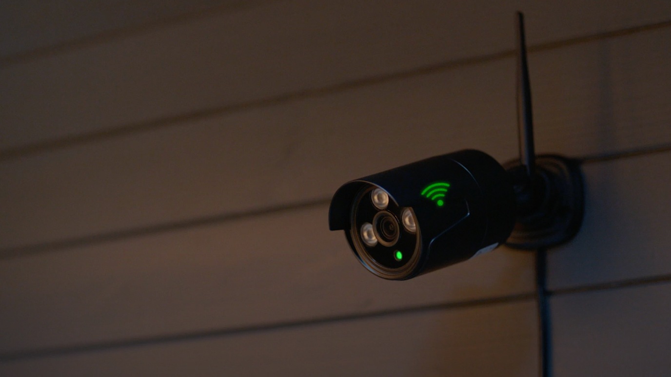 Wireless security camera mounted on wall