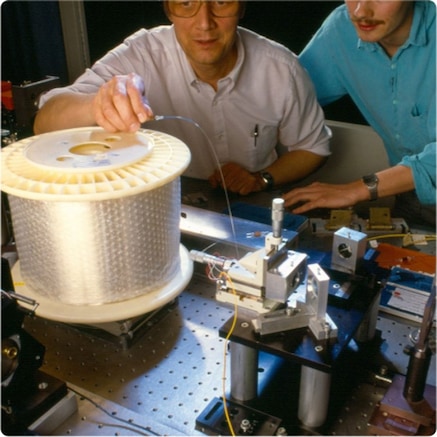 Two engineers conducting solition test on fiber optic cable