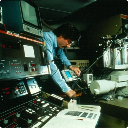 Engineer adjusting electronic equipment in laboratory