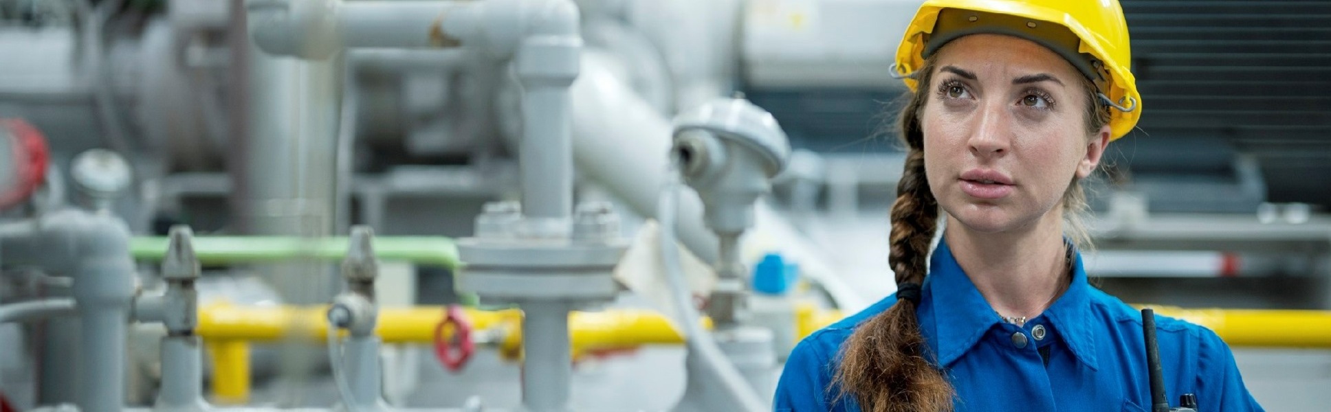 Woman in coveralls in a chemical manufacturing plant