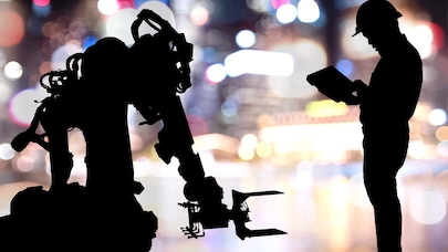 An image of two silhouettes against a bright, blurry background - one is a robot and the other one is a human wearing a safety helmet.