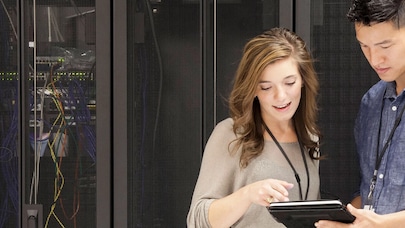Two people looking at a clipboard.