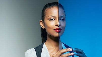 A woman and her image in the mirror.