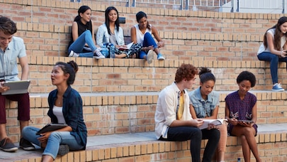 An image of people sitting on big stairs.