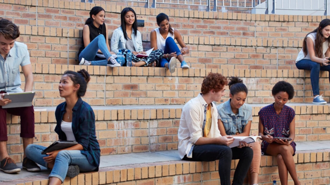 A picture of people sitting on big stairs.