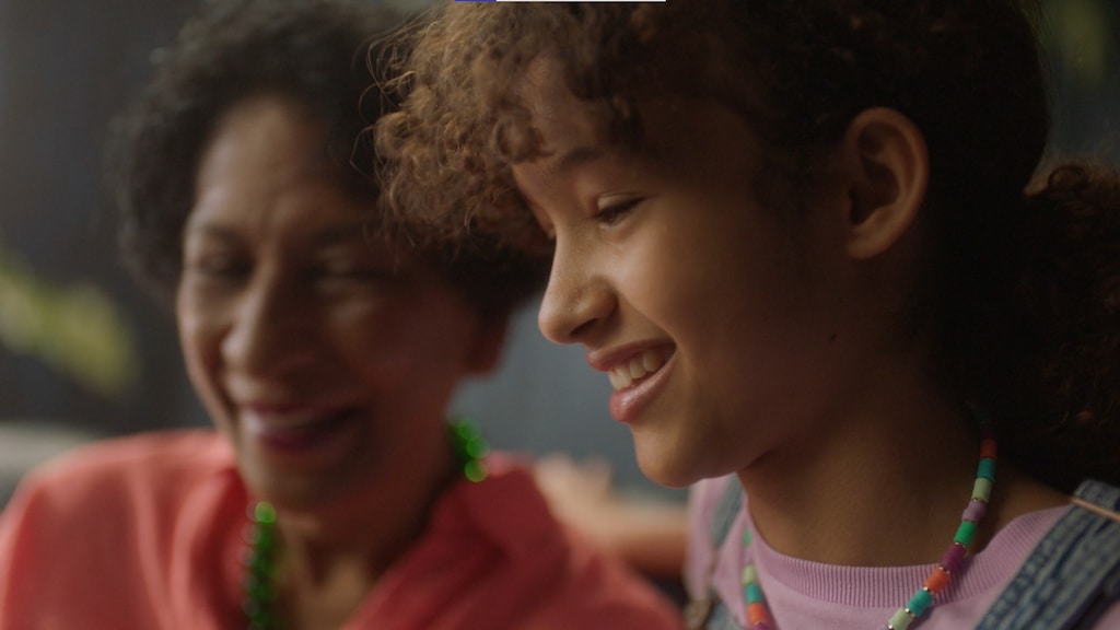 a girl and adult smiling