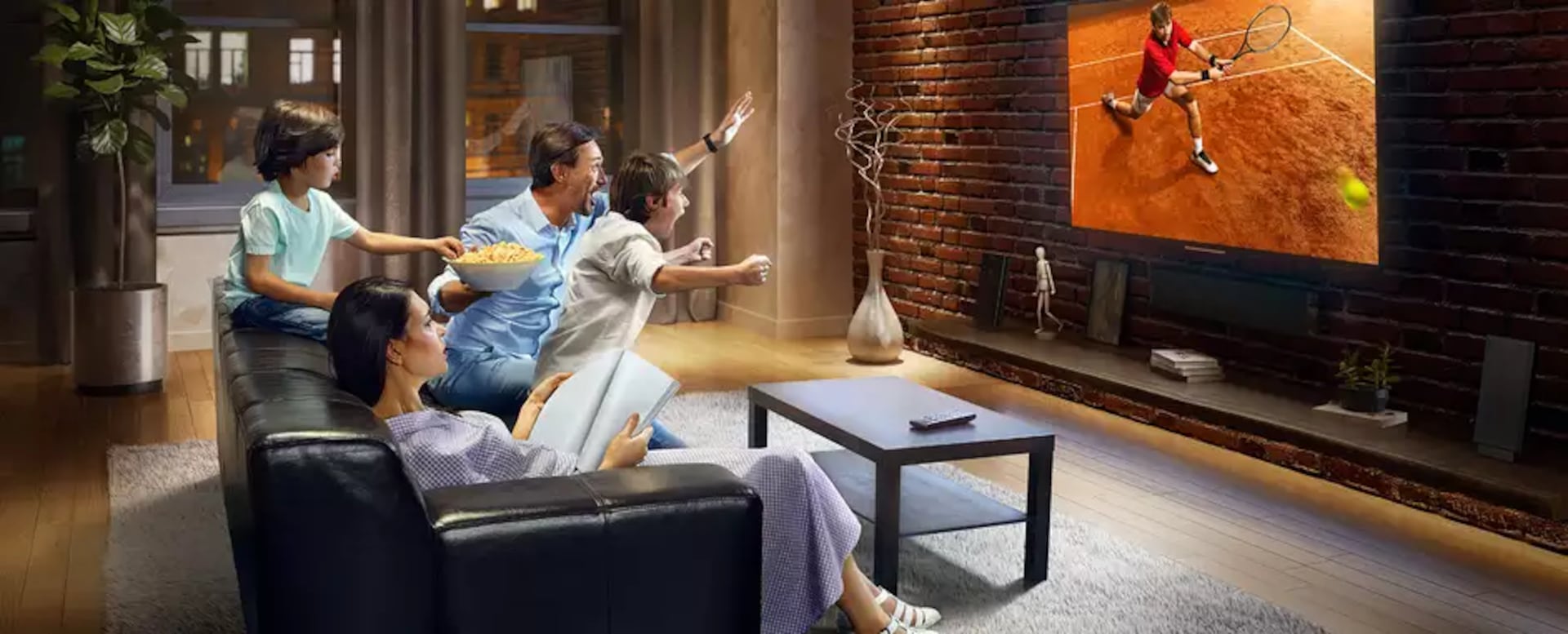 A family watching a tennis match on tv.