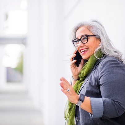 A woman with glasses talking on a mobile phone