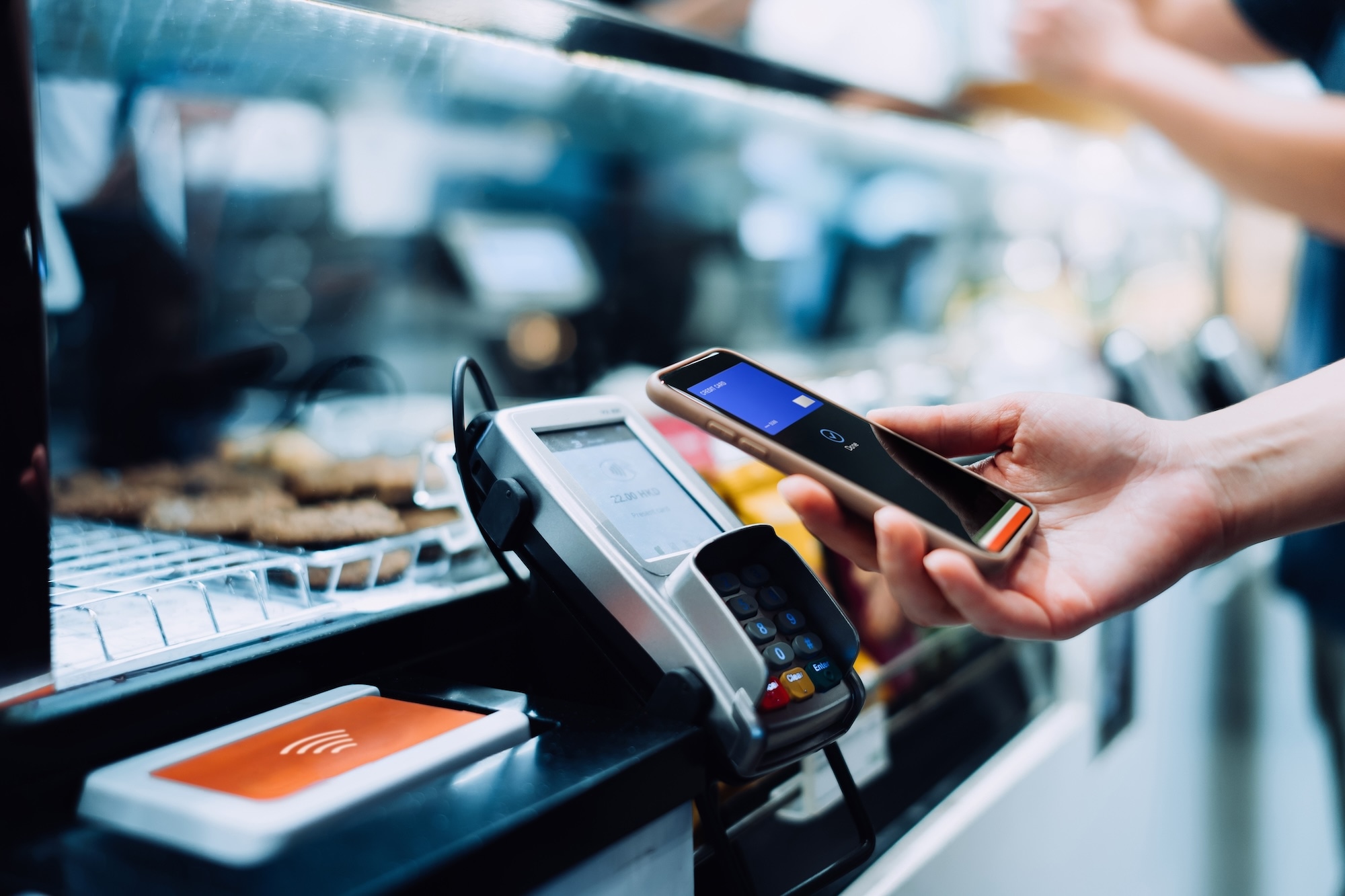 Hand paying on terminal with smartphone