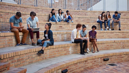 Students sitting on brick amphitheater steps