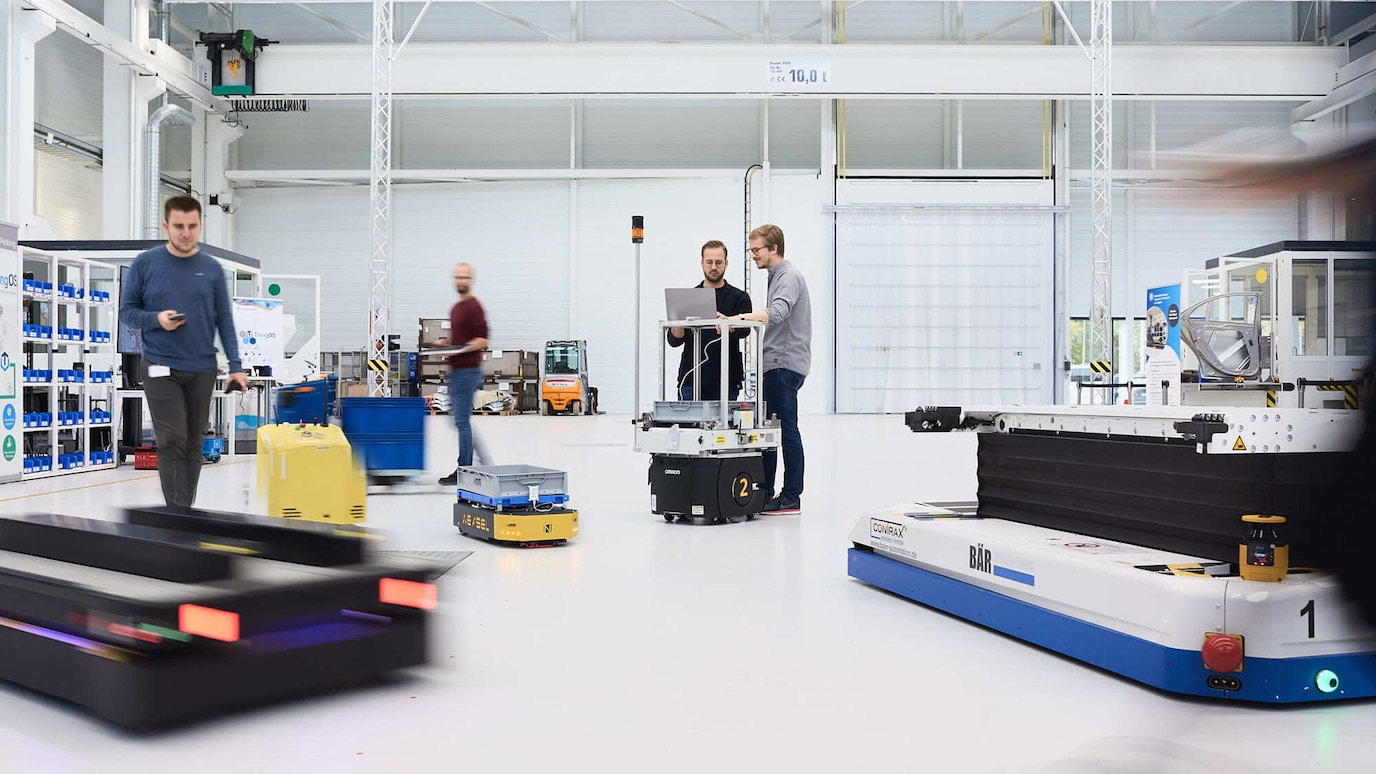 Warehouse worker steer remote controlled pallet trucks