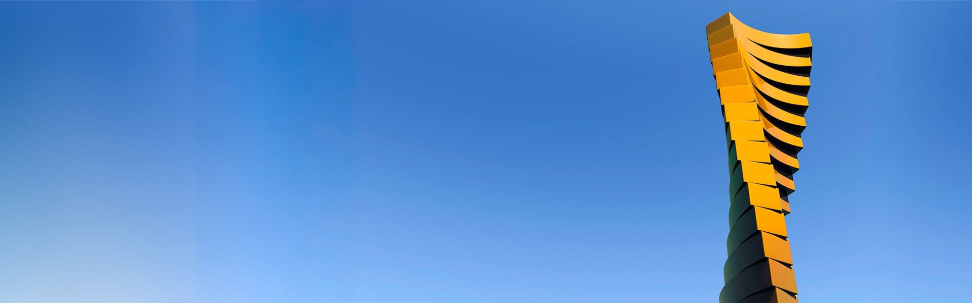 Twisting tower against a blue sky