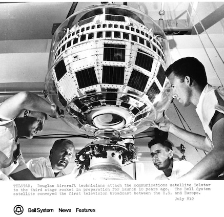 Douglas Aircraft technicians attach communications satellite Telstar