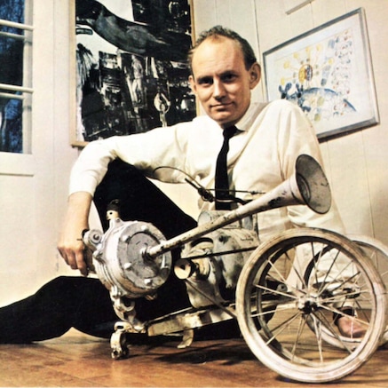 Bill Klüver poses with a piece of the self-destructing machine