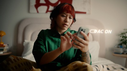 Teenager using smartphone in bedroom