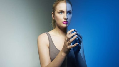 Woman standing infront of colored glass