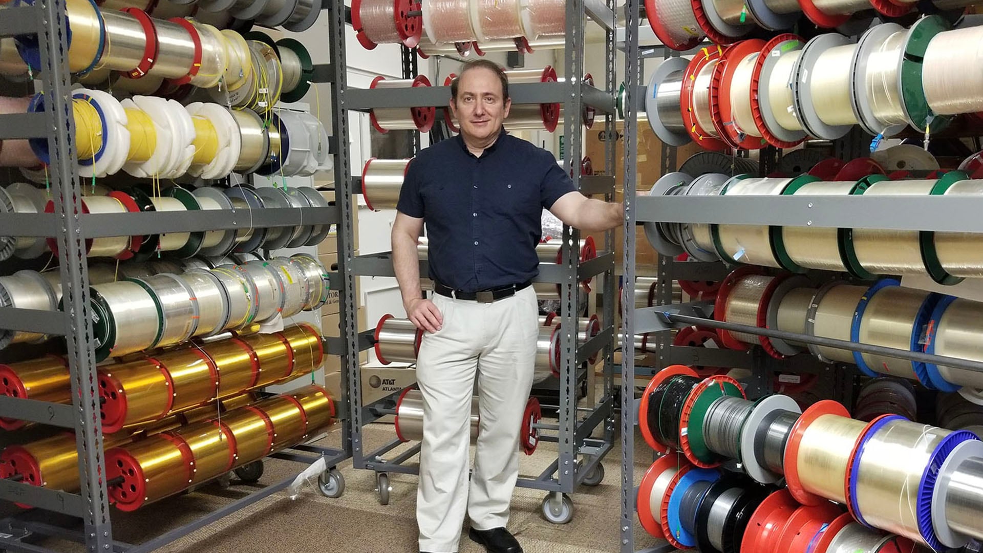Rene Essiambre standing amonst optical fibers