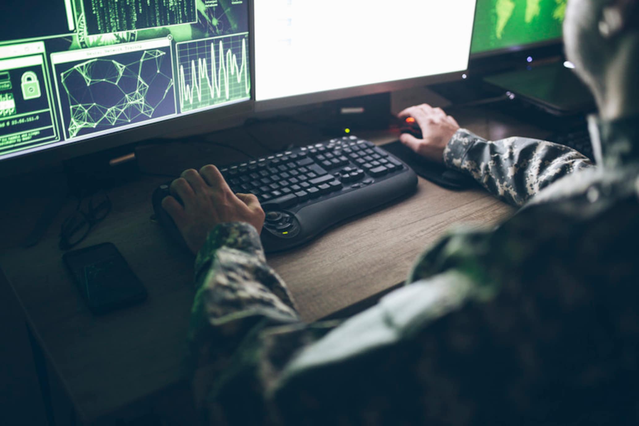 an military officer working in an operations center
