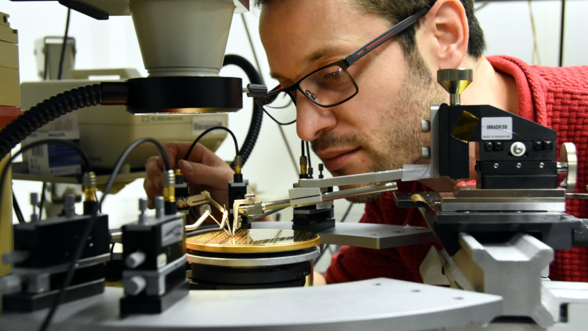 Joan Ramirez working with a III-V integrated laser on a silicon wafer