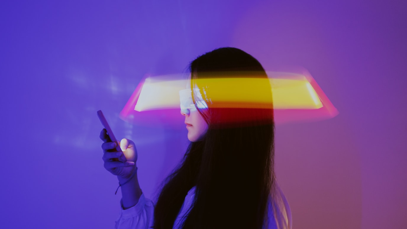 Woman wearing smart glasses holding a smart phone