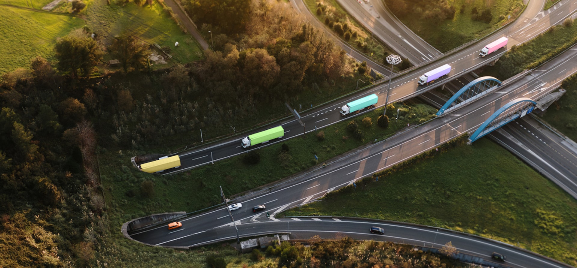 Trucks on road leading into tunnel though hill