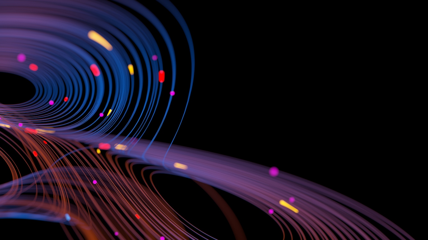Abstract digital visualization of colorful curved light trails and particles on a black background