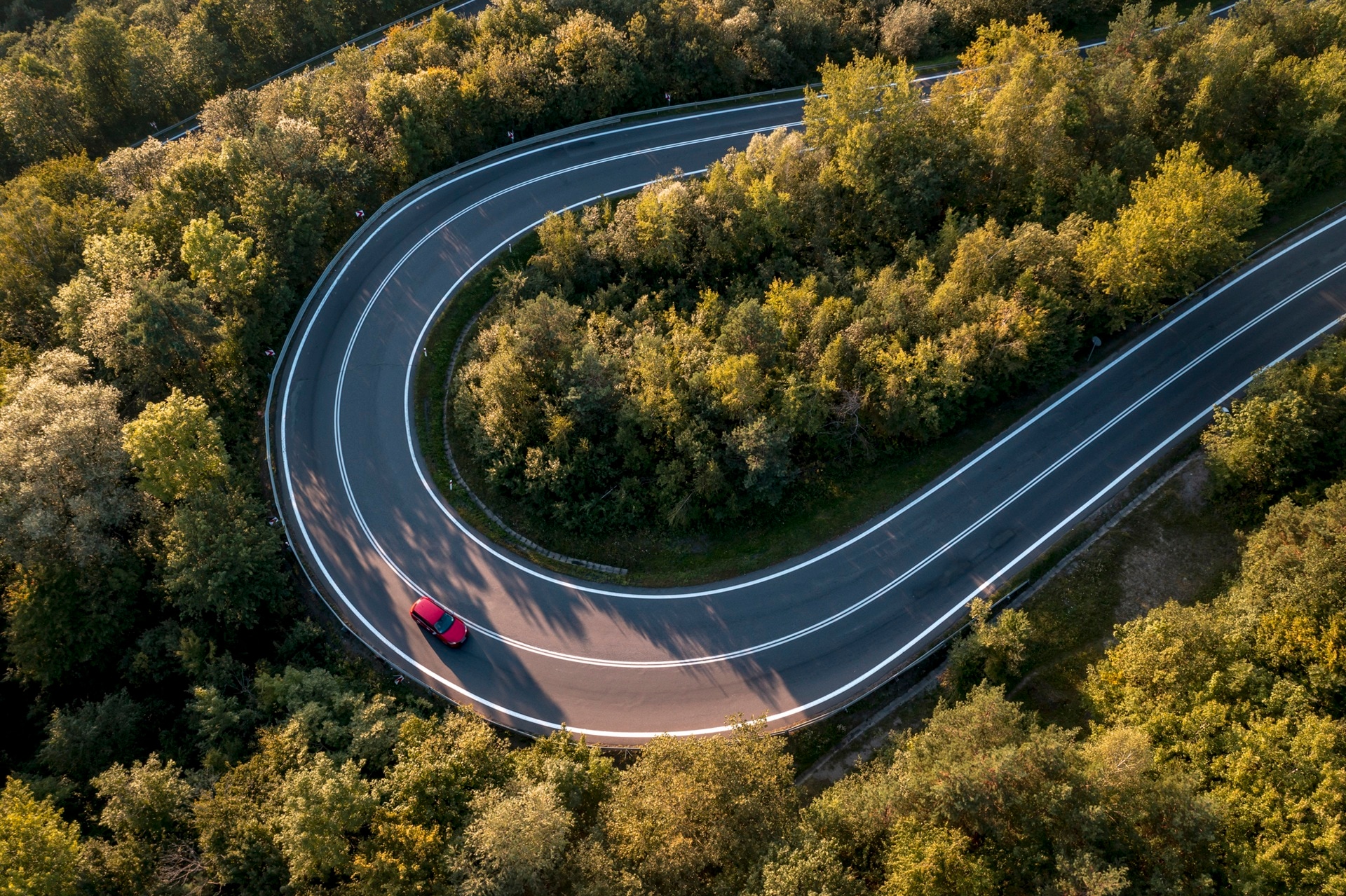 red car winding road
