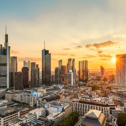 Sun setting over city skyline