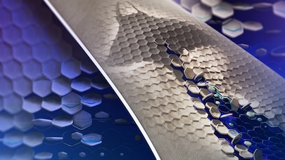 Close-up of textured hexagonal surfaces morphing with digital blue and green elements, symbolizing smart materials innovation.