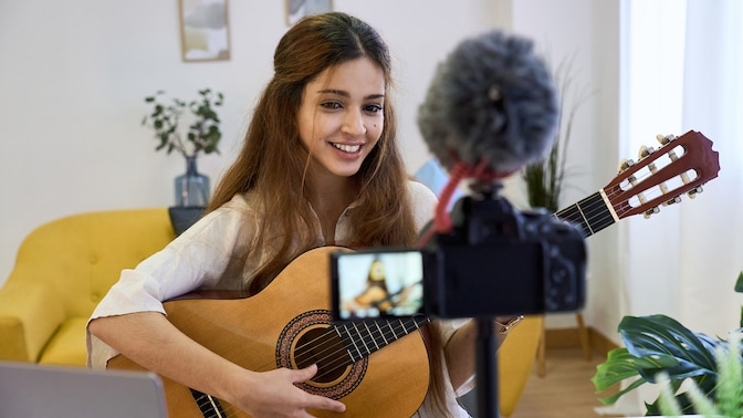 Woman video video streaming herself playing guitar