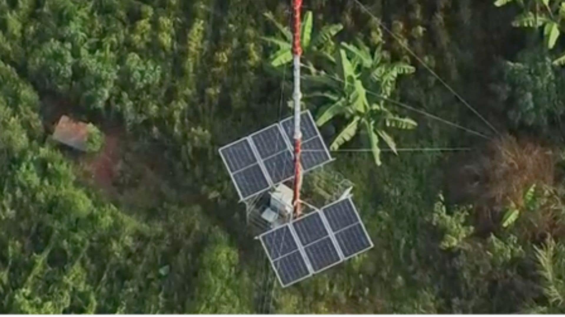 Solar-powered telecom tower in a rural green area providing sustainable connectivity for remote and unconnected communities.
