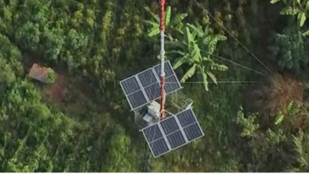 Solar-powered telecom tower in a rural green area providing sustainable connectivity for remote and unconnected communities.