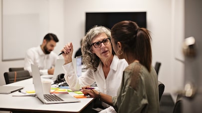 Two women in discussion at a meeting