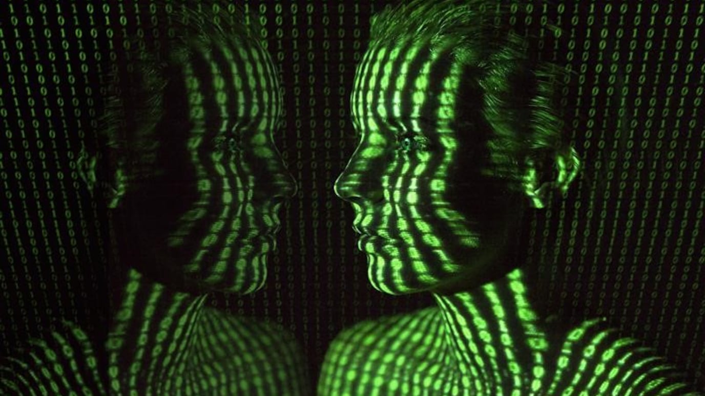 Digital art of human faces with binary code projection, symbolizing AI, data, and technology in a futuristic theme.