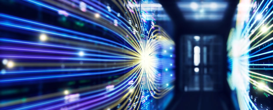High-speed data transfer visualization showing glowing fiber-optic network cables in a modern data center corridor.