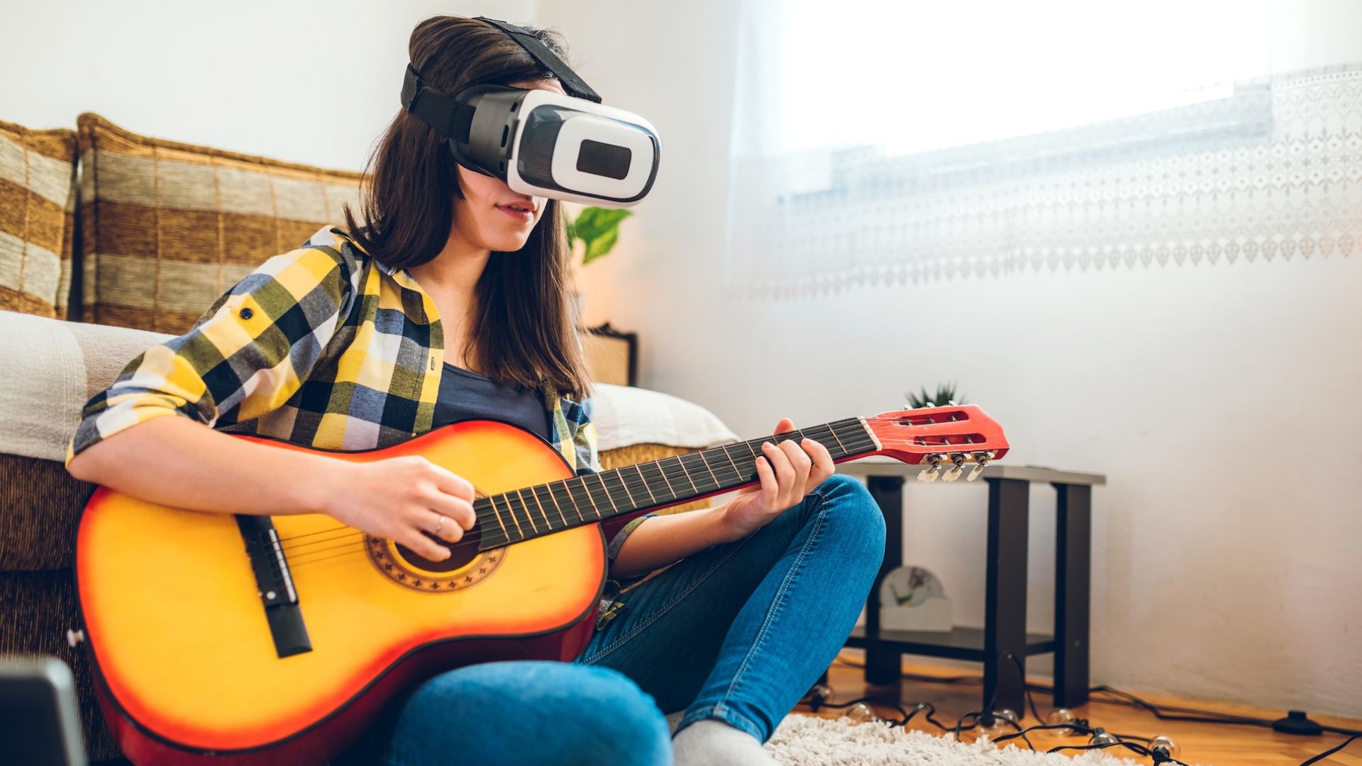 Young woman is using extended reality headset to learn how to play acoustic guitar