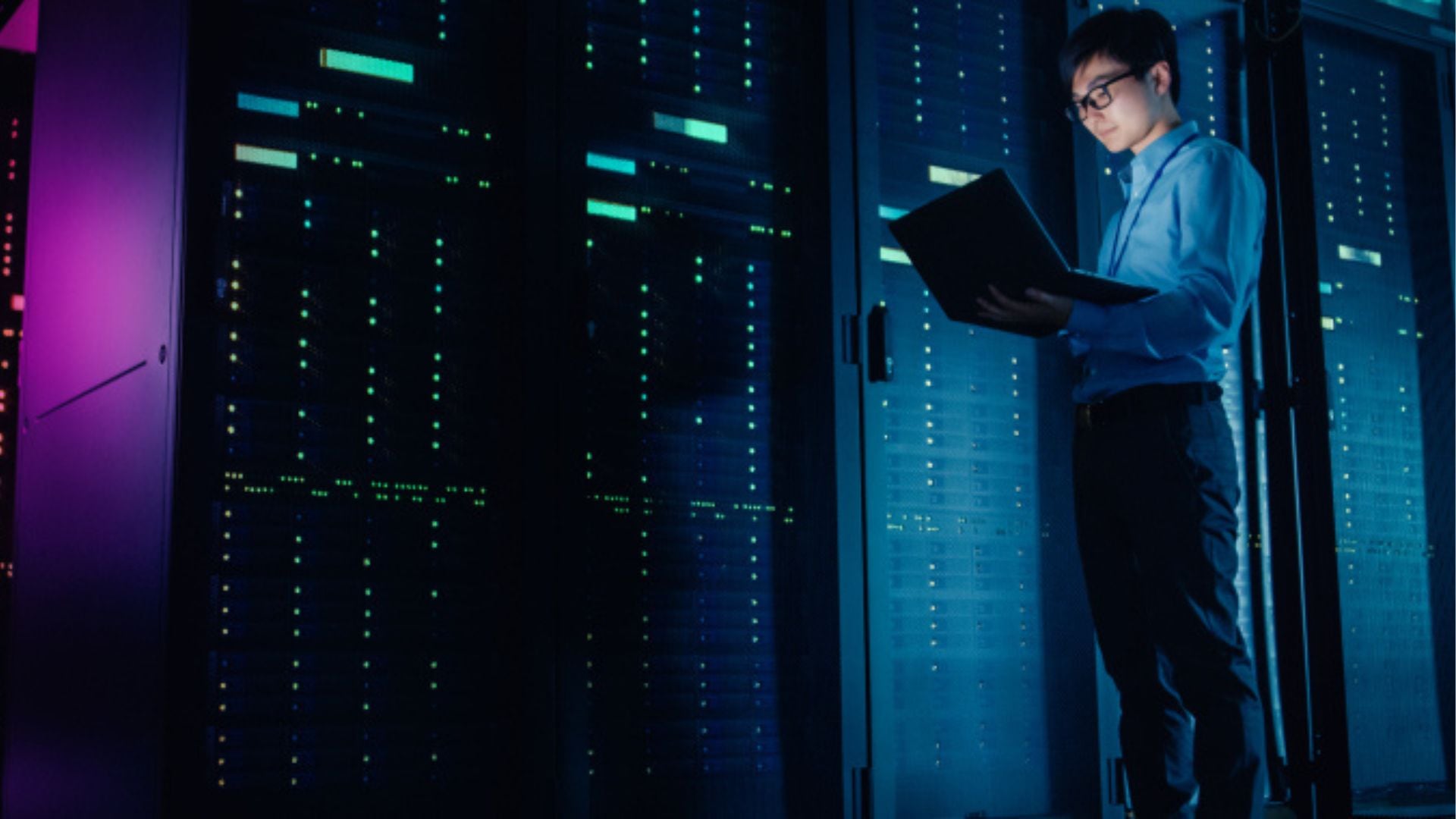 IT professional managing servers in a modern data center with glowing lights and secure network infrastructure.