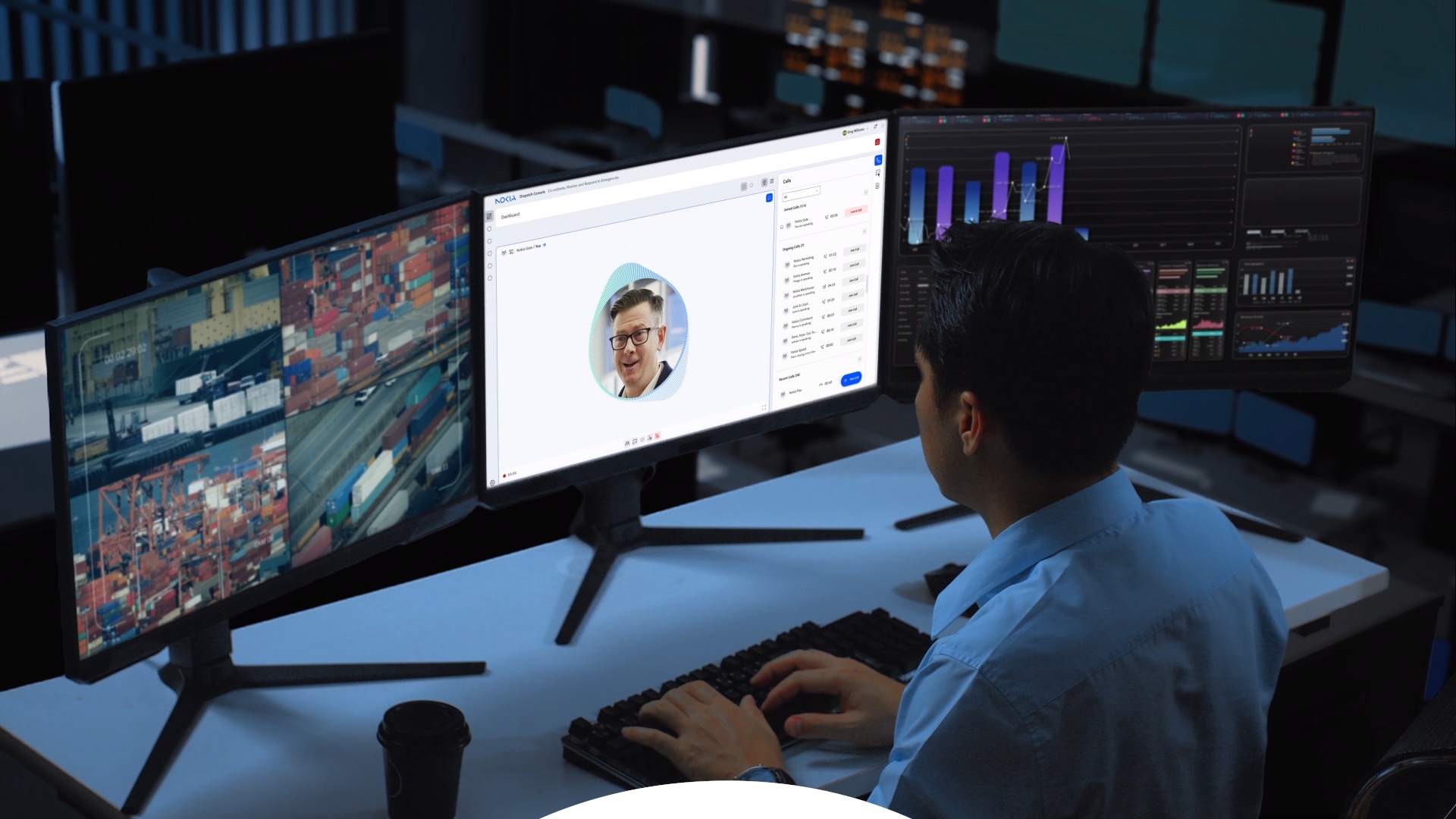 A man sitting in front of multiple computer monitors