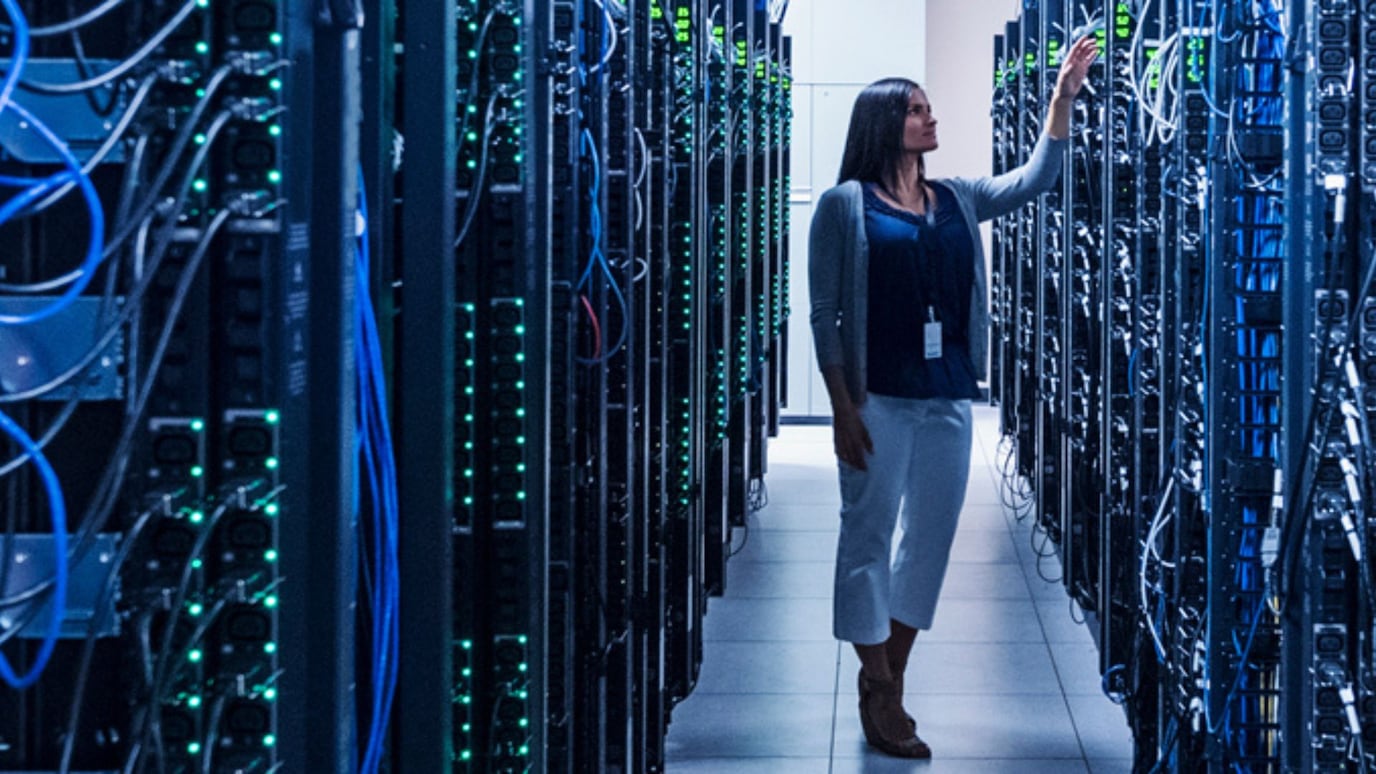 Female IT worker checks the server room