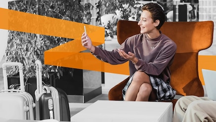 Woman sitting in chair looking at smartphone