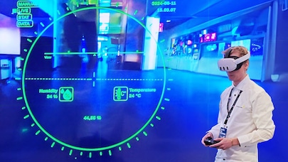 Man wearing VR headset with remote controller in his heands