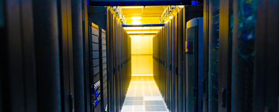 Data center aisle with yellow lights