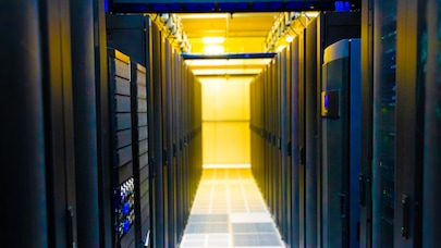 Data center aisle with yellow lights