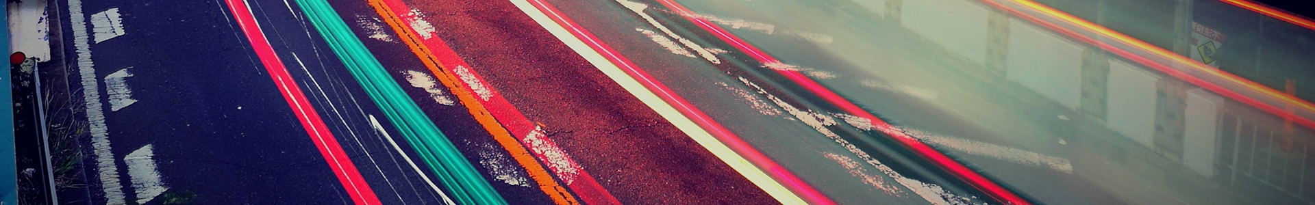 City road at night lit by trailing car lights