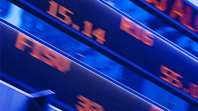 Blurred, red digital numbers on a blue electronic board