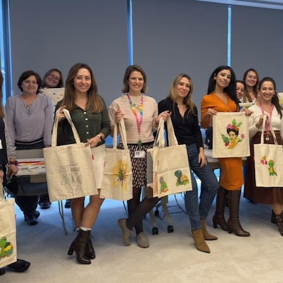 Workshop attendees holding bags