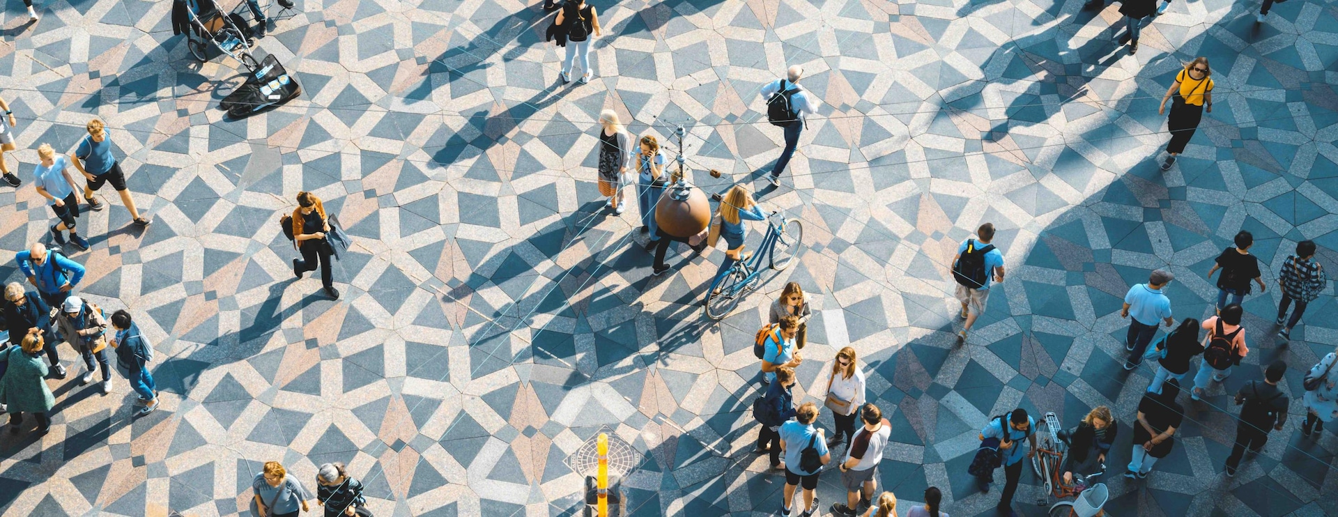 People walking across a public square.